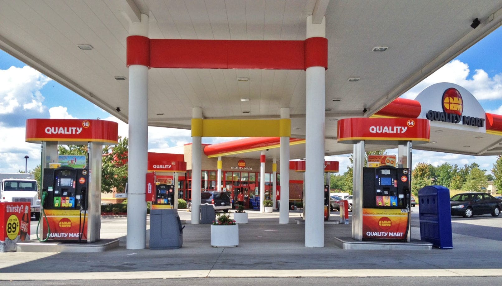 In front of the pumps at a Quality Mart gas station